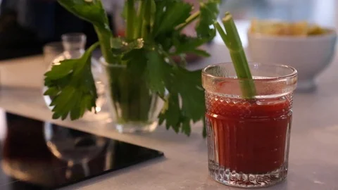 Handheld close-up shot of freshly served Bloody Mary with celery Stock Footage 114846811