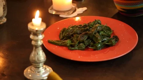 Handheld close-up shot of fried pepper in a dish on dining table 스톡 동영상 114846807