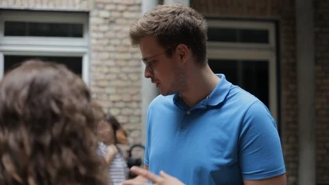Handheld close-up shot of a man explaining an idea to his friends 스톡 동영상 114847168