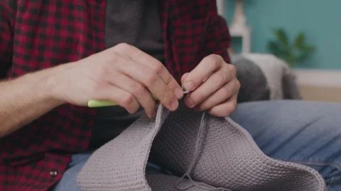 Handheld close up shot of man hands knitting Video stock 107353192