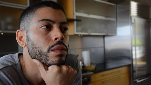 Handheld close-up shot of a man looking away and smiling Video stock 115060000