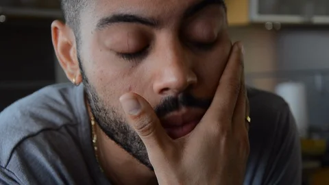 Handheld close-up shot of a man looking stressed out and sipping wine Video stock 115060004