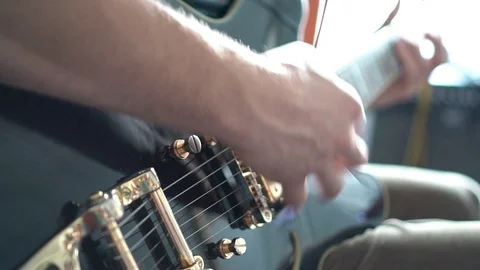 Handheld close-up shot of man playing guitar Stock Footage 114843818