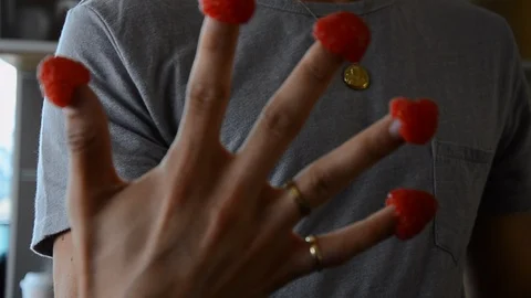 Handheld close-up shot of a man playing with raspberries in the kitchen Video stock 115059991