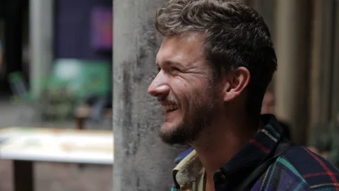 Handheld close-up shot of a man talking to his friend at the event 스톡 동영상 114847206