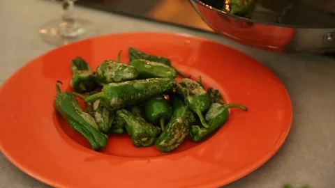 Handheld close-up shot of a person serving fried pepper in the plate Video stock 114846758