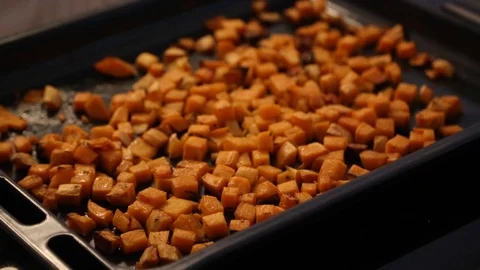 Handheld close-up shot of roasted carrots in a baking pan Stock Footage 114846694