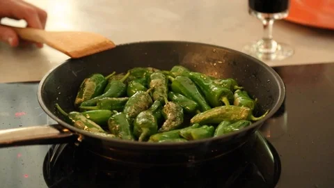 Handheld close-up shot of roasted pepper in frying pan on the stove Stock-Footage 114846749