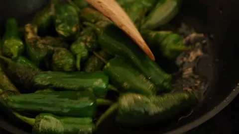 Handheld close-up shot of roasted pepper in frying pan Stock Footage 114846752