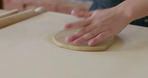 Handheld close up shot of scraping a piece of flat clay, Stock Footage 277212353