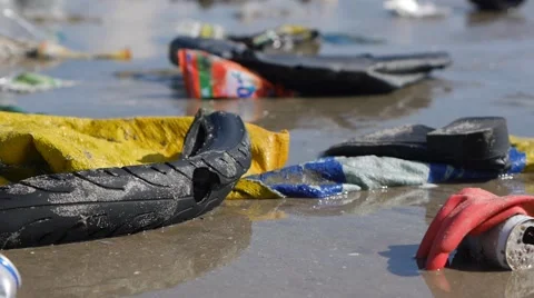 Handheld close up shot of trash and rubbish on the shore of a tropical sea Stock-Footage 50786815