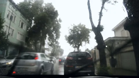 Handheld close up shot of a windshield wiper inside a car on a rainy day Stock Footage 83393751