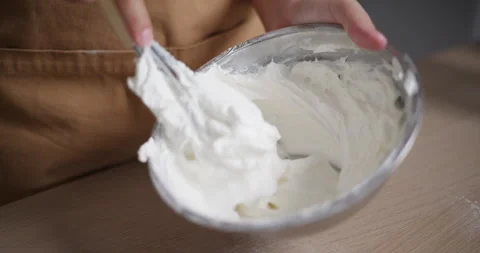 Handheld close-up shot, Woman's hands are using a hand whisk to beat ingred.. Stock-Footage 308224081