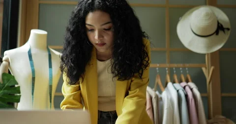 Handheld close up shot, Young beautiful woman fashion designer working  Stock Footage 225407847