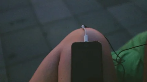 Handheld close-up of a smartphone on a womans lap Stock Footage 122397486