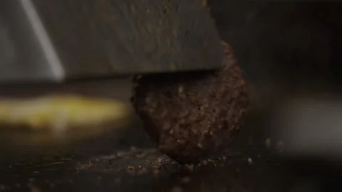 Handheld Close-Up Spatula Flipping Pressing Burger Flat Top Grill Stock Footage 334486616