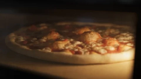 Handheld close up view of cheese pizza baking in the oven Stock Footage 117545782