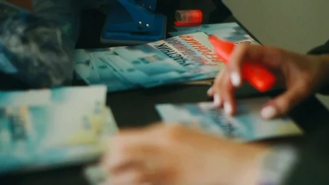 Handheld close-up of a womans hand writing on a pamphlet 库存影片 122396327