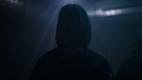 Handheld close of woman's head from the back then walks away Video stock 114848270