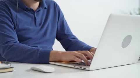 Handheld closeup of man typing on laptop in office Video stock 162467772