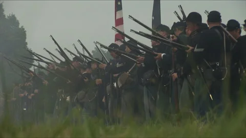 Handheld "Combat Camera" with a Union Firing line - Civil War Battle reenactment Stock Footage 184439379