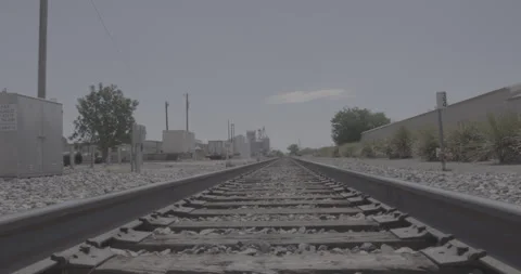 Handheld Crane Up Shot From Train Tracks in Rural Texas Town Stock Footage 246441725