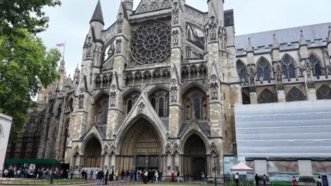 Handheld crowd movement at Westminster Abbey west facade on overcast day Stock Footage 346678211