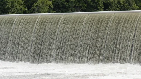 Handheld dam overflowing water creating a waterfall Stock Footage 107876338