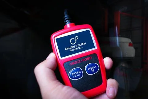 Handheld engine diagnostic obd tool in use for car fixing Foto stock