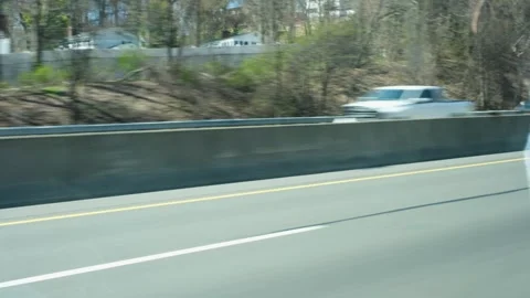 Handheld of Fast motion blur of vehicles and white van on suburban highway Stock Footage 332680308