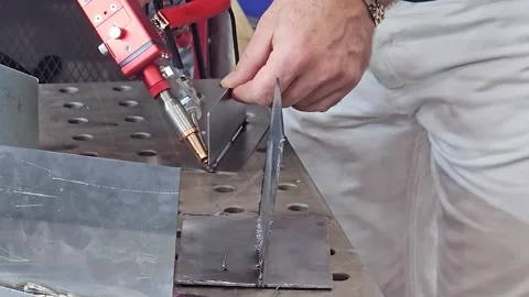 Handheld Fiber Laser Welding Process on Metal Sheet in Factory Workshop Stock Footage 337396203