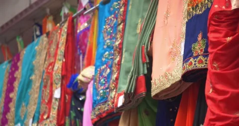 A handheld focus shift close-up shot of colourful glitter Sarees, Indian 스톡 동영상 289888619