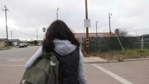 Handheld footage of kid walking to school Stock Footage 155388599