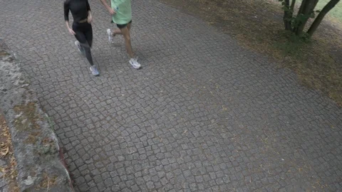 Handheld high angle view of man and woman running together Video stock 114843761