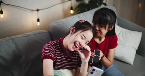 Handheld high angle view shot, Two Asian siblings pose for a selfie happily.. Stockbeeldmateriaal 305146746