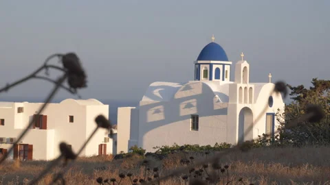 Handheld of an iconic Greek blue domed church on Santorini at magic hour Stock-Footage 239479215