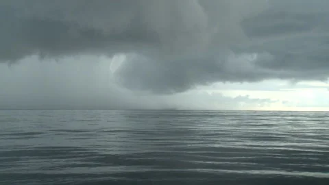 Handheld long shot of a man kayaking while a storm is brewing Stock Footage 310540113
