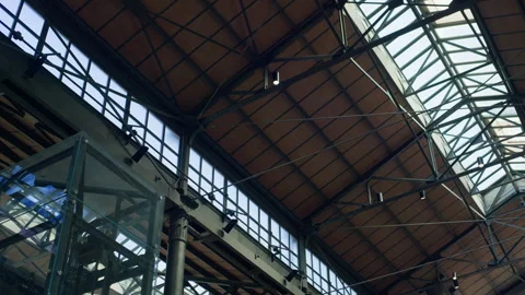 Handheld Low-Angle Pan of Warehouse Ceiling with Metal Trusses and Lights Stock Footage 315819669