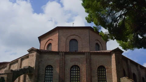 Handheld Low-Angle Shot of Brick Basilica Upper Section with Clear Sky Stock Footage 315779676