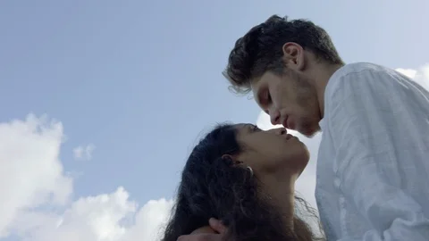 Handheld low-angle shot of a young loving couple looking deep into each other's Stockbeeldmateriaal 116066456