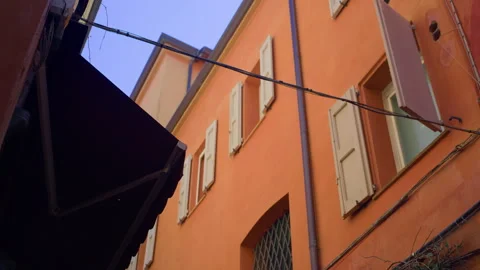 Handheld Low-Angle Still of Building Facade in Alley with Blurred Bar Awning Stock Footage 315814869