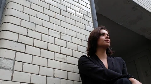 Handheld low angle view of beautiful woman sitting and posing Video stock 120422464