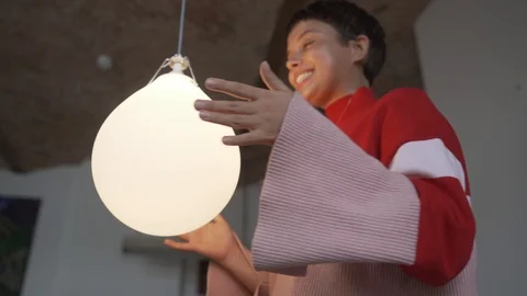 Handheld low angle view of young woman dancing with light equipment Stock Footage 120422837