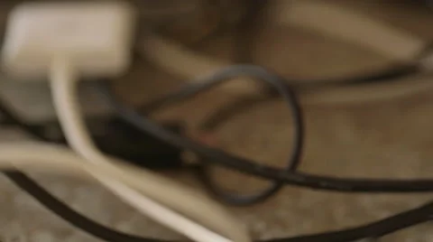 Handheld Macro of Tangled Cables Next to Old iPhone 動画素材 68723644