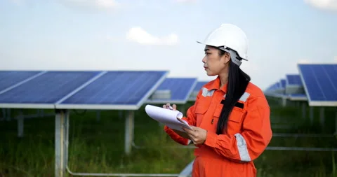 Handheld medium shot, Asian Young engineer woman wearing protection uniform Stock Footage 224260290