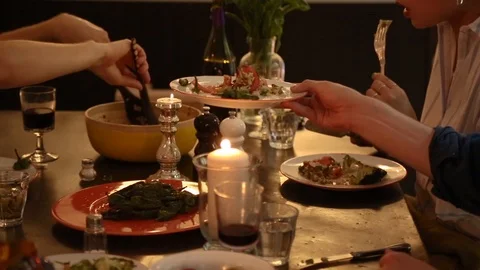 Handheld mid section shot of a friend serving meal on the dinner table Video stock 114846688