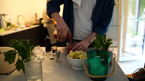Handheld mid section shot of a man pouring a drink in the glass Stock Footage 114884585