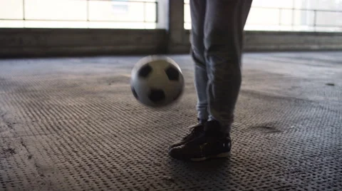 Handheld mid shot of soccer freestyle player doing tricks with the football Stock Footage