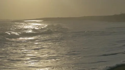 Handheld Ocean Waves Gently Crashing Against The Shore at Depok Beach  Stock Footage 302524144