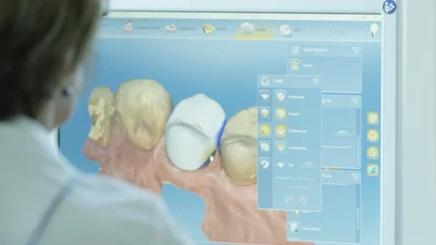 Handheld over the shoulder view of dentist using 3D dental technology Stock Footage 113716691